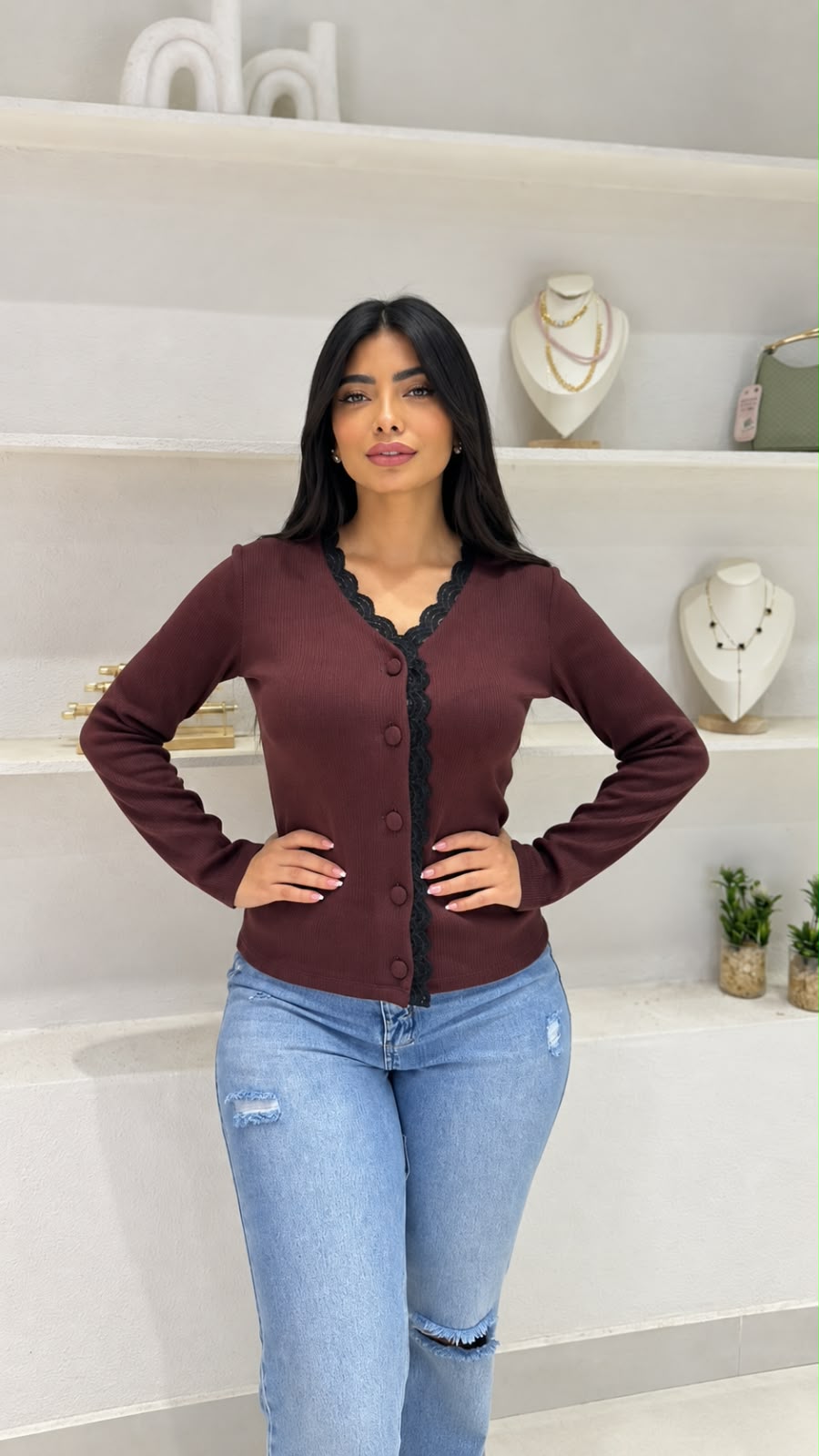 An elegant ribbed-knit cardigan, embellished with scalloped lace trim.