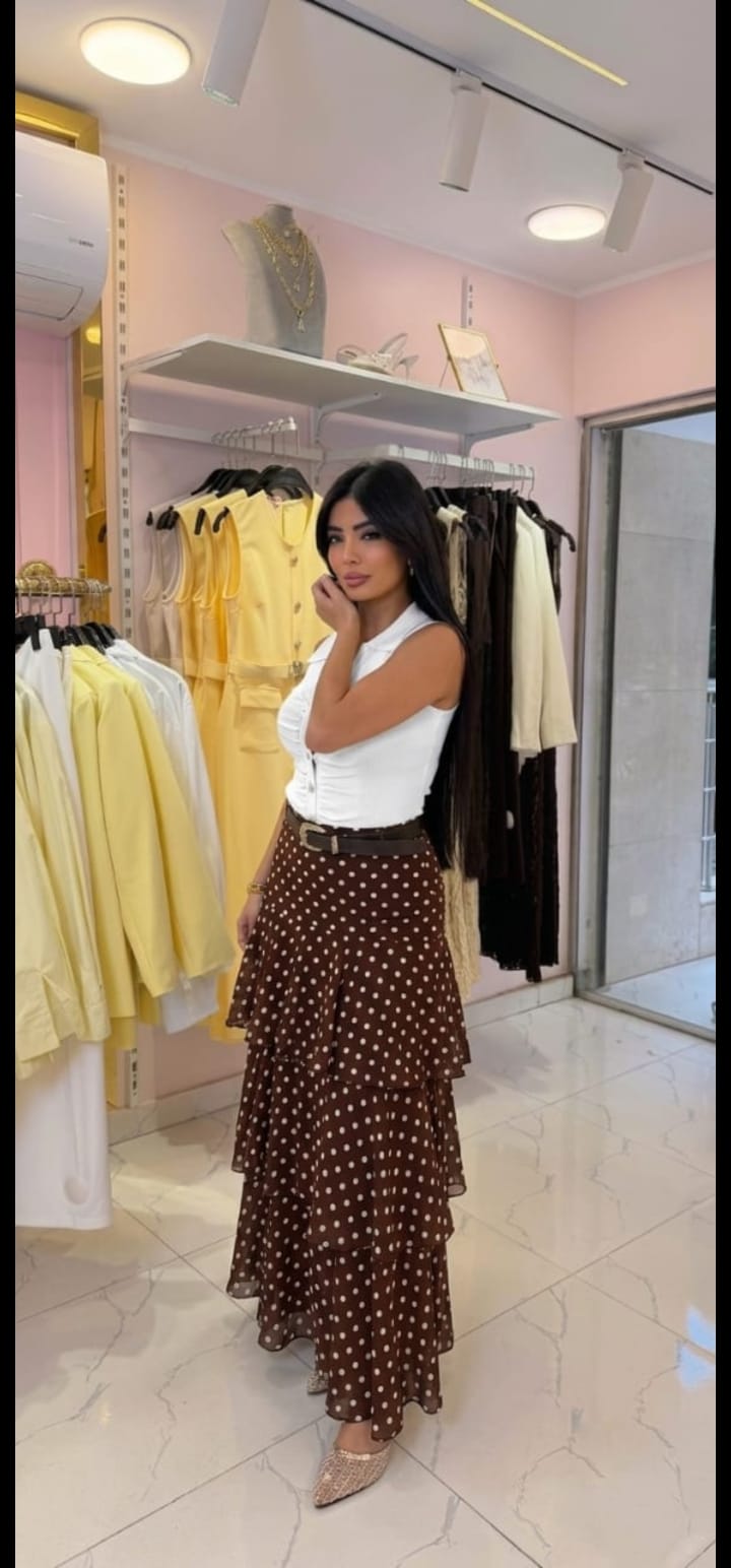 Elegant midi skirt featuring ruffles and a polka-dot print.