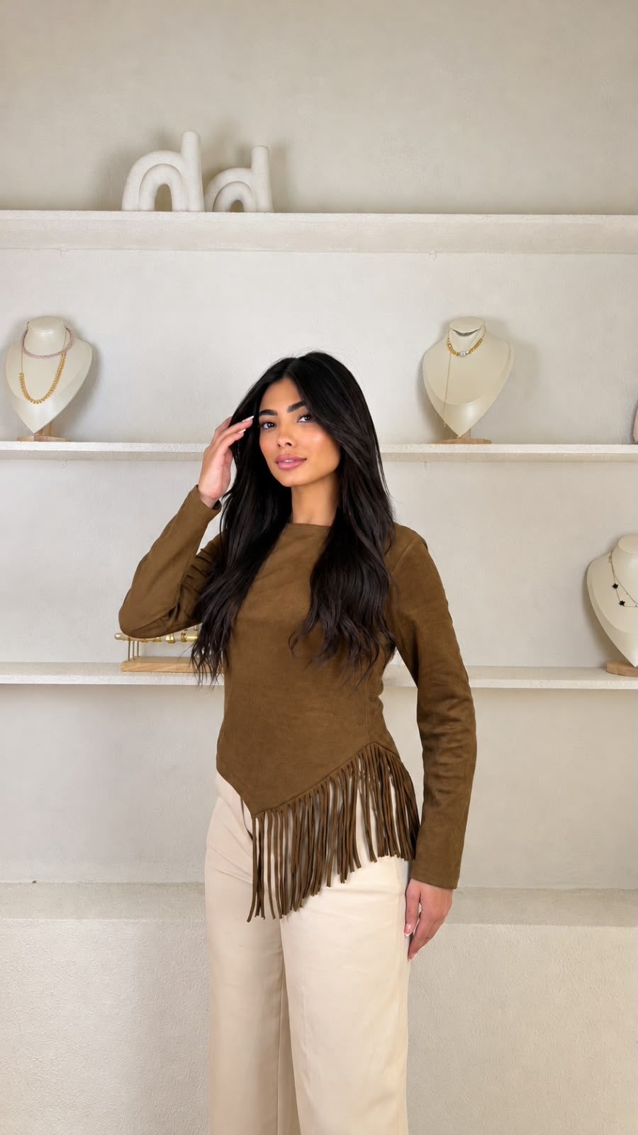 Long-sleeved faux suede top with an asymmetric fringe hem