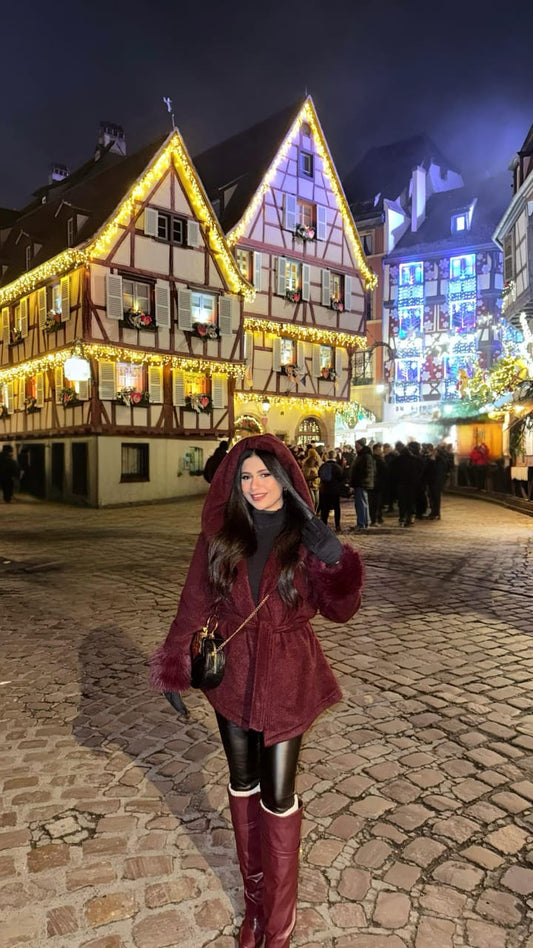 A stylish and comfortable look for a winter evening: a wrap coat trimmed with faux fur.