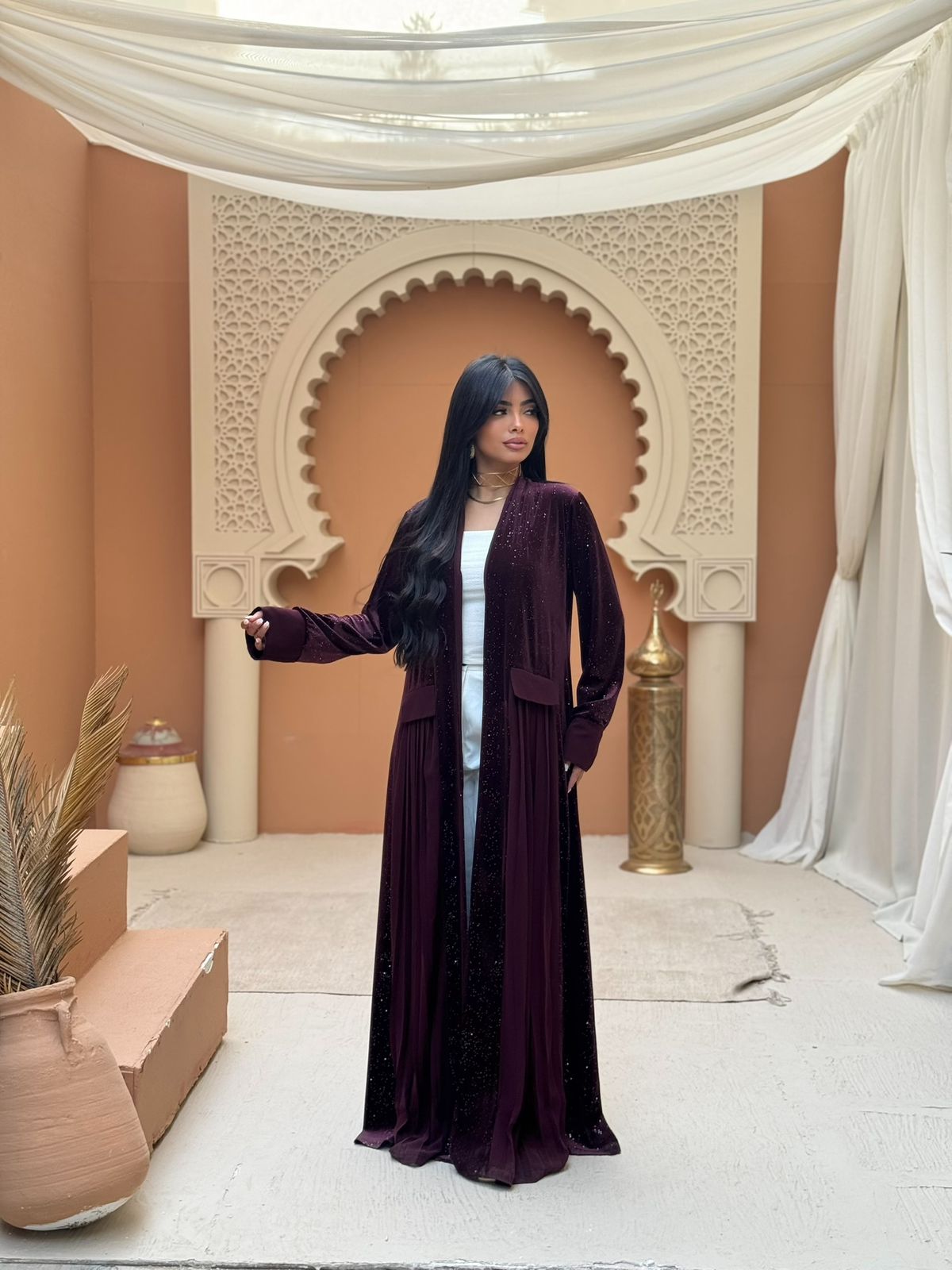 A pleated Ramadan abaya with a shimmering midnight color design