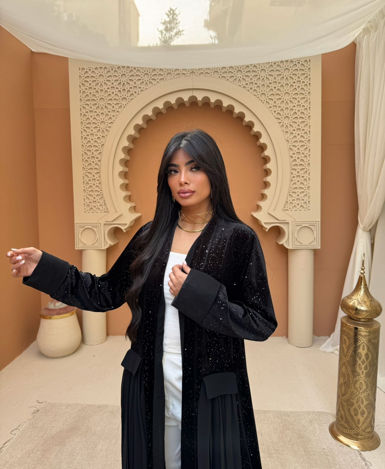 A pleated Ramadan abaya with a shimmering midnight color design