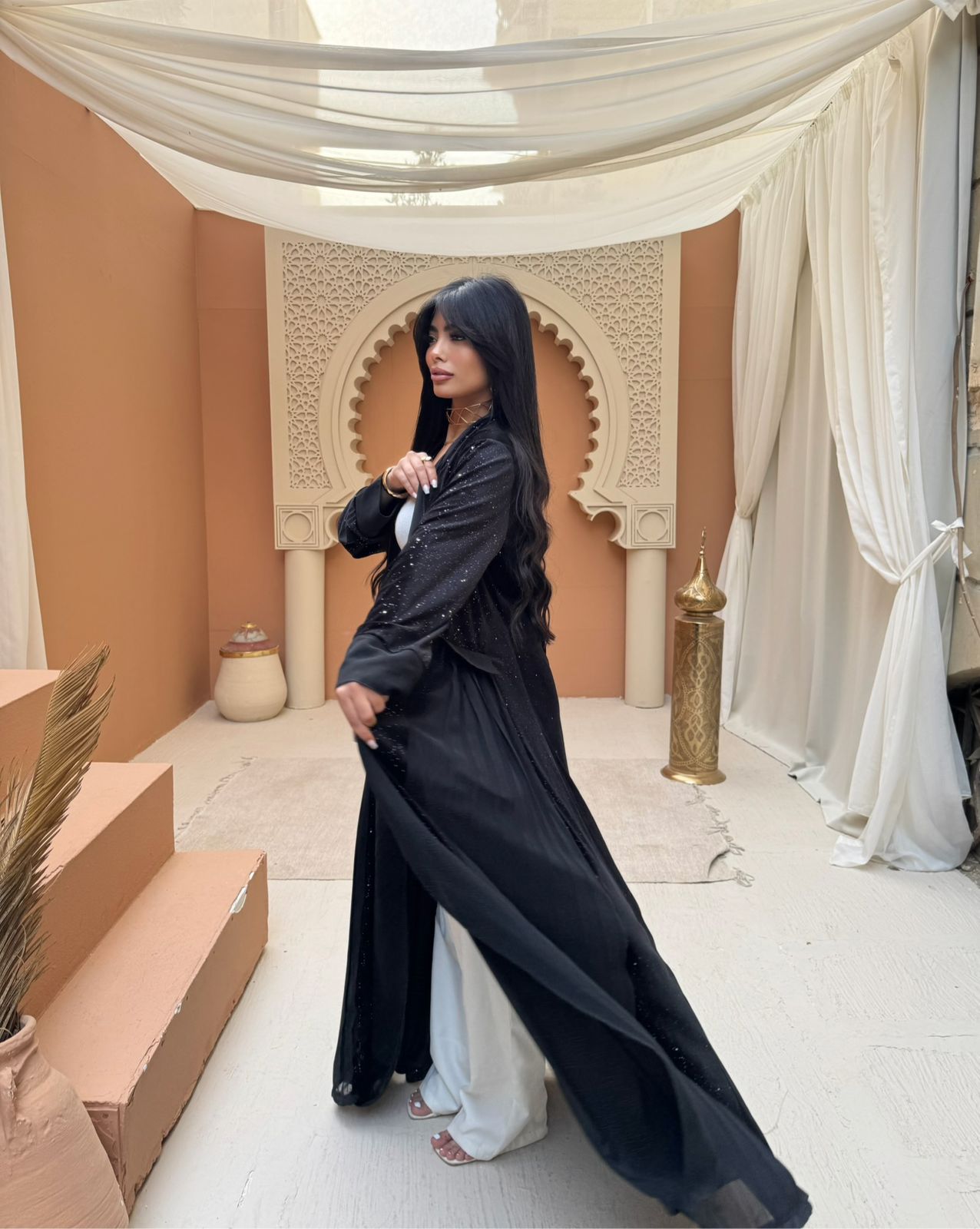 A pleated Ramadan abaya with a shimmering midnight color design